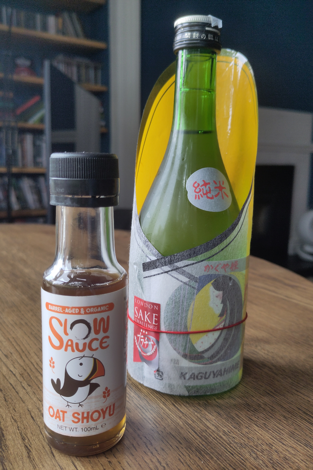 A bottle of Slow Sauce oat shoyu beside a bottle of Kaguyahime junmai sake